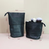 Black stretchable PU leather makeup brush storage case with a drawstring closure and brush holders.