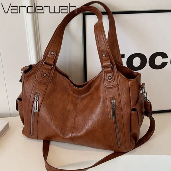 A brown leather tote bag with a multi-pocket design is shown against a white background.