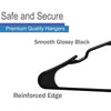 A close-up view of a smooth glossy black clothing hanger with a reinforced edge.