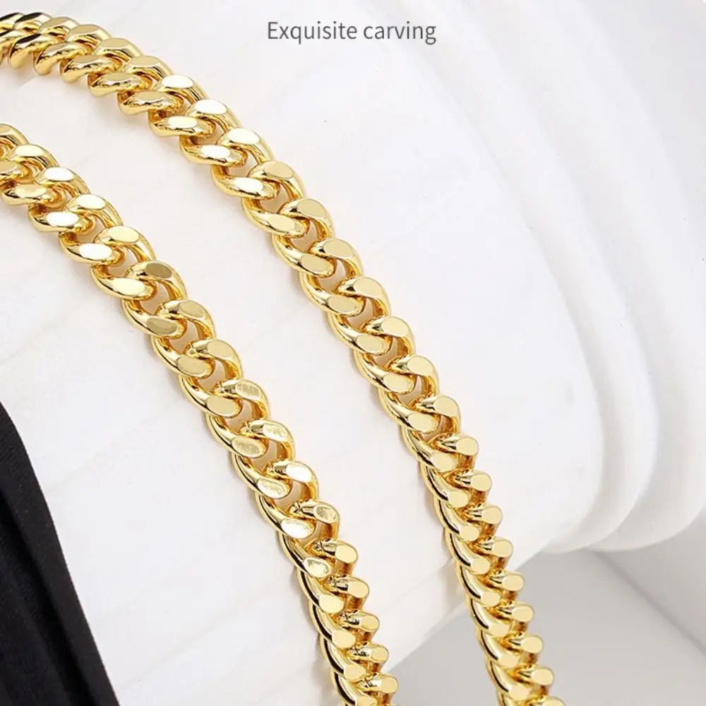A close-up of a gold-colored, exquisite carved chain strap for bags.
