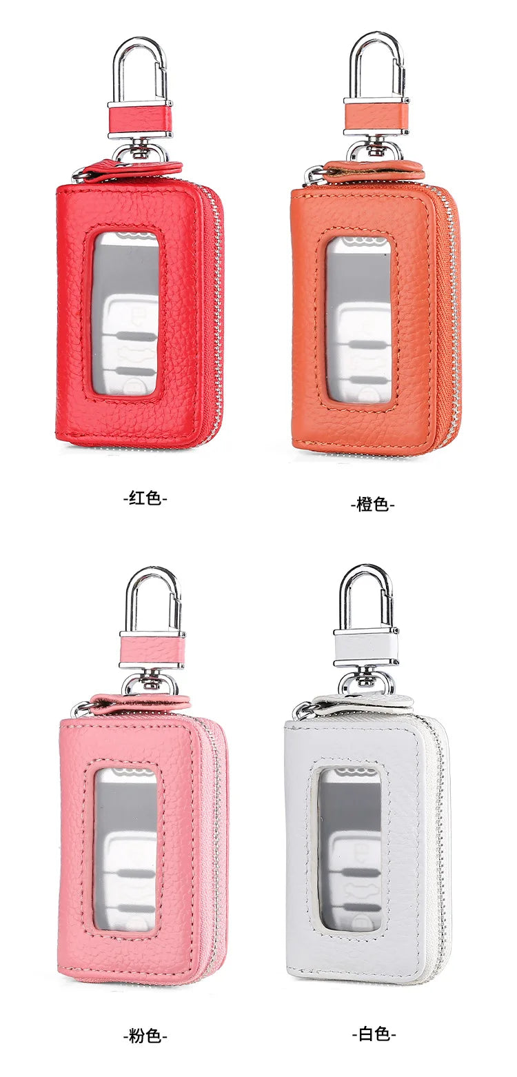 A set of leather car key cases in red, orange, pink, and white with transparent windows and silver clasps.
