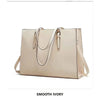 A beige large capacity laptop tote bag with a crocodile texture shown against a white background.