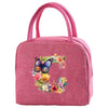 A pink insulated canvas lunch bag featuring a colorful floral design.