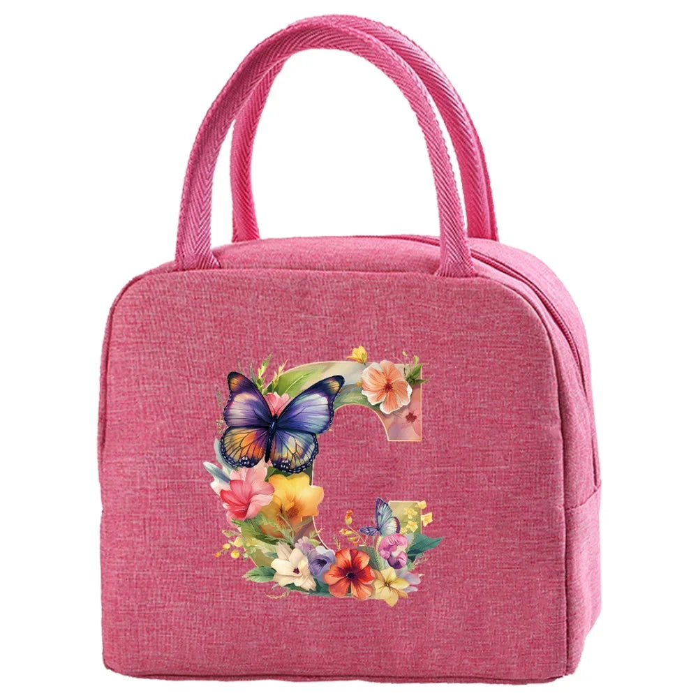 A pink insulated canvas lunch bag featuring a colorful floral design.