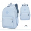 Light blue durable nylon commuter backpack shown from the front and side view.