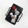 Black mesh drainage shower tote with a handle containing various skincare and grooming products