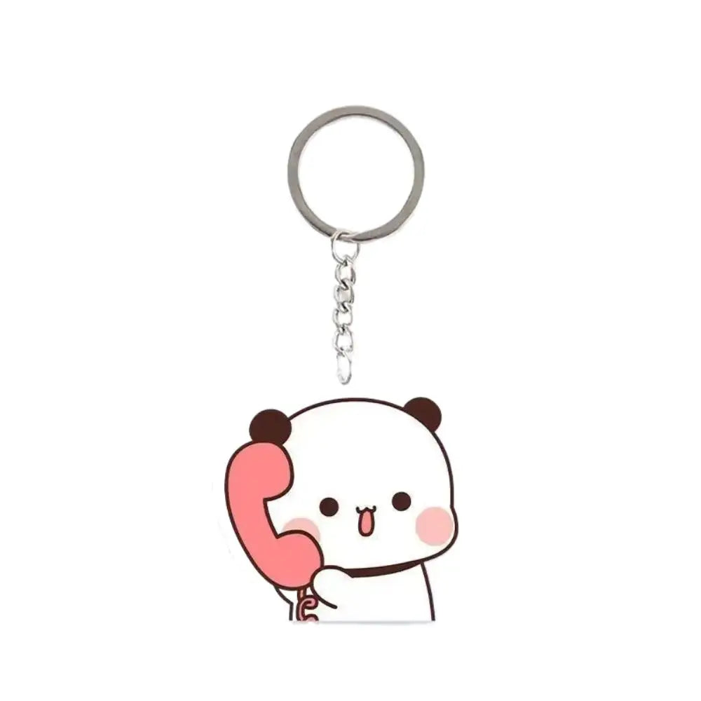 A white cartoon panda face charm with pink ears and a red phone receiver attached to a silver keyring.