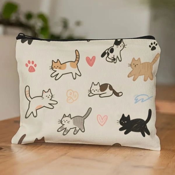 A cream-colored pouch featuring a repeating pattern of simple line drawings of cats in various poses.