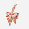 Pink floral patterned adjustable bag strap with a gold ring closure