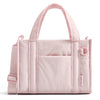 A light pink quilted crossbody tote bag with a fabric handle and pocket detail.