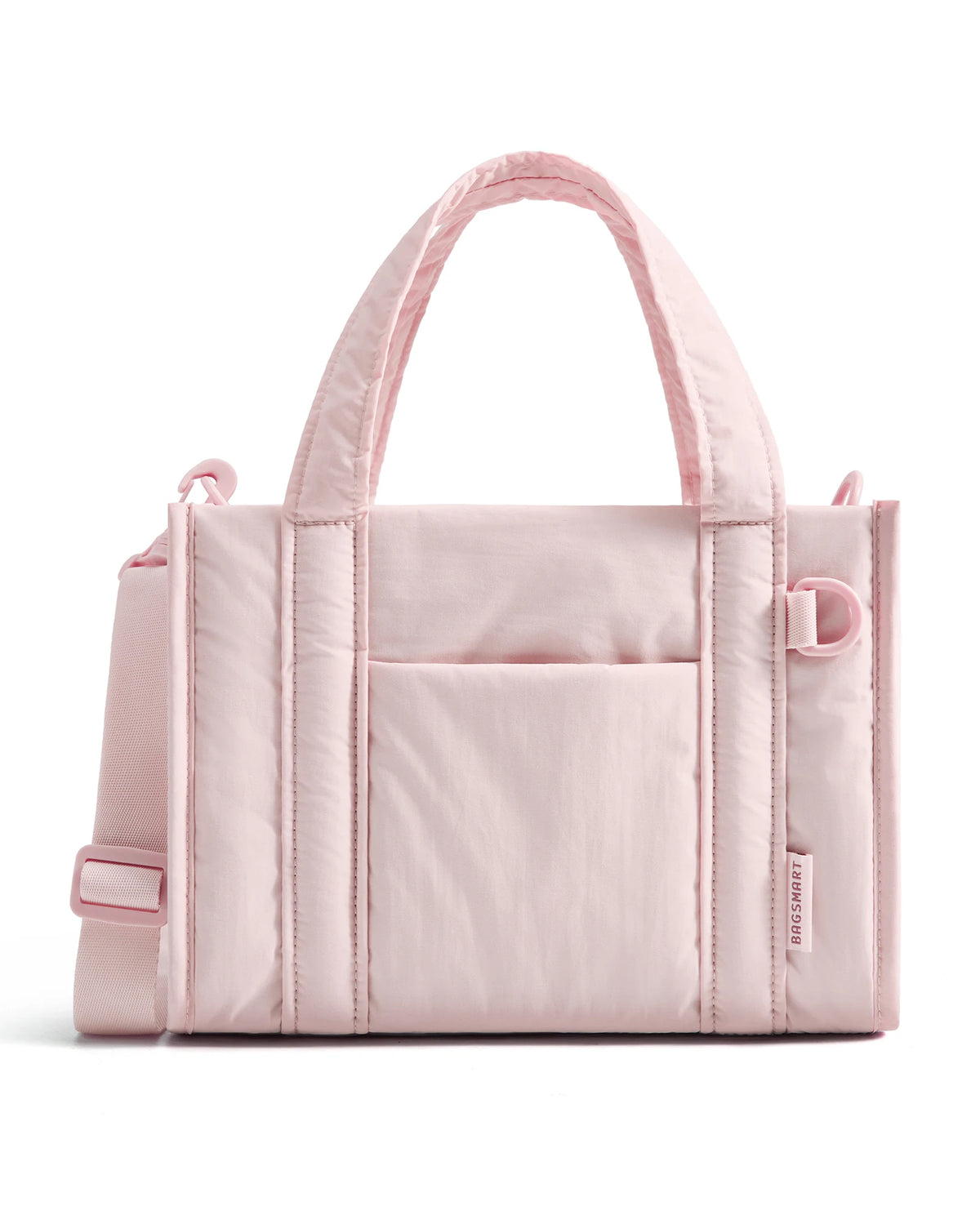 A light pink quilted crossbody tote bag with a fabric handle and pocket detail.