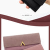 A hand holds a black tri-fold PU card holder wallet with a gold accent and a pink version.