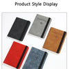 A display of various passport organizers in black, gray, brown, and red leather.