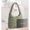Daily-carry size of a quilted green nylon shoulder bag shown next to an iPad mini and some papers.