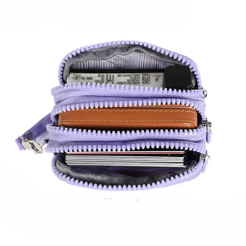 A purple nylon zipper pouch with multiple layers, including a brown leather strip and a clear plastic section.