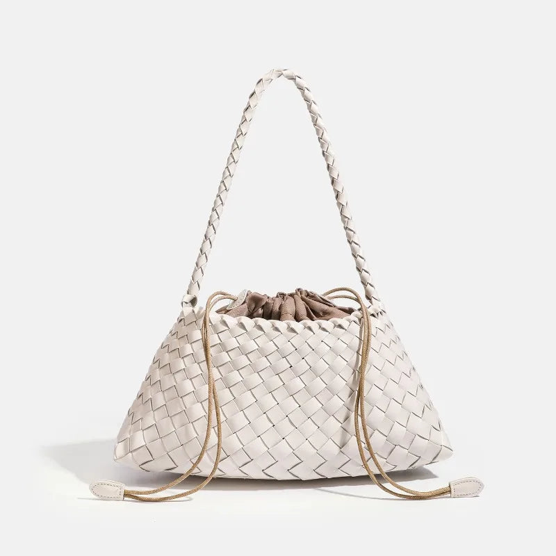 A cream-colored handwoven PU shoulder bag with a woven texture and long leather straps.