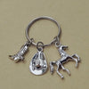 Silver keychain set featuring a cowboy boot, hat, and horse silhouette.