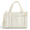 A cream-colored lightweight quilted crossbody tote bag with a handle and flap pocket.