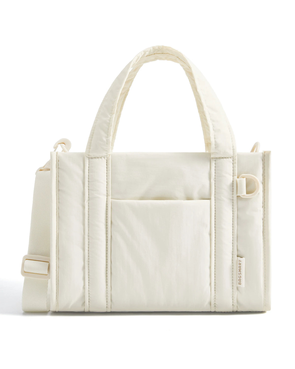A cream-colored lightweight quilted crossbody tote bag with a handle and flap pocket.