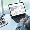 A person is using a laptop to view an application while several travel cable organizers and accessories are displayed on a li