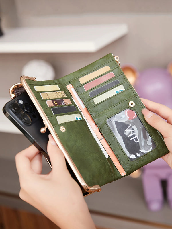 A hand holds an open olive green vintage zipper wallet displaying various cards and a phone.
