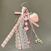 Pink strawberry bag charm keychain with pink ribbon and lace details