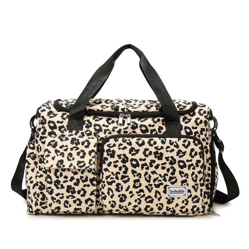 A beige leopard print travel duffel bag with black straps and a separate shoe compartment.