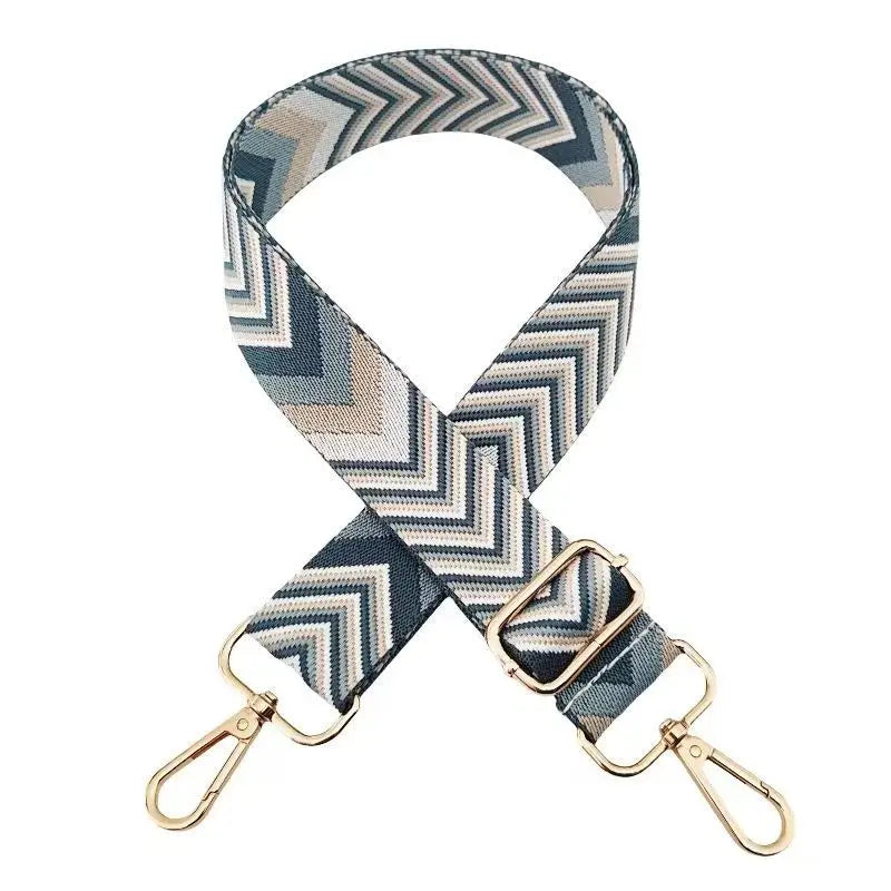 A patterned nylon bag strap featuring gray, beige, and navy chevron designs.