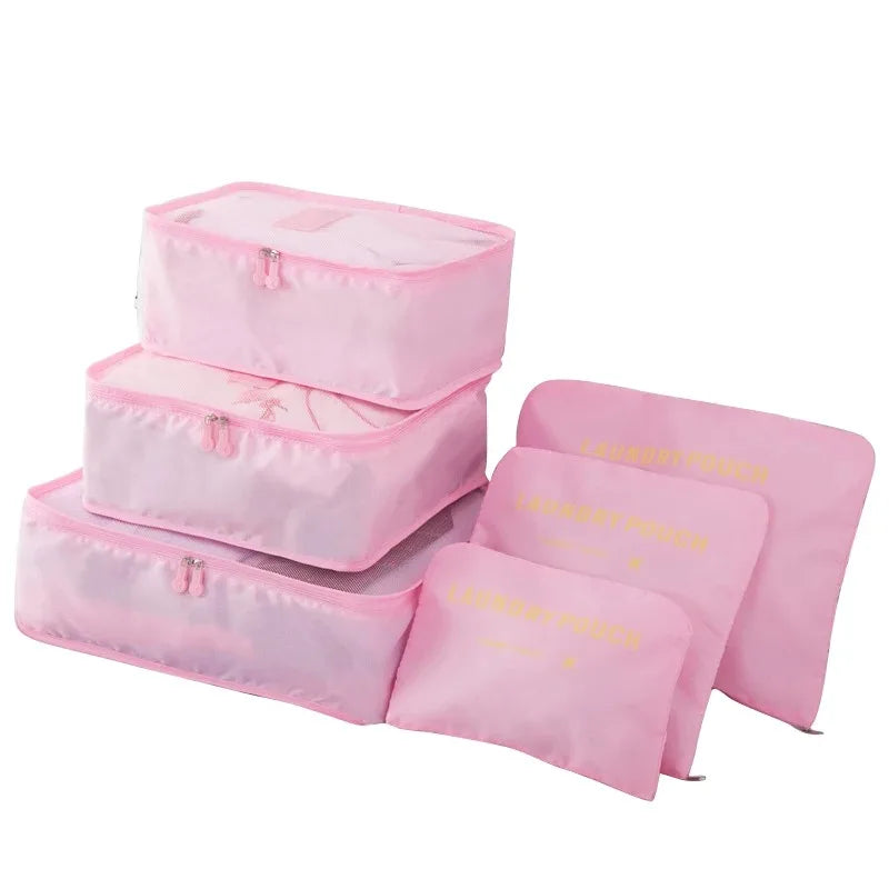 A set of pink mesh packing cubes for travel organization, shown in various sizes.