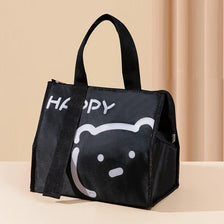 Black insulated lunch bag featuring a happy bear face design.