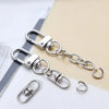 Silver swivel keychain hooks and clasps displayed on a light background.