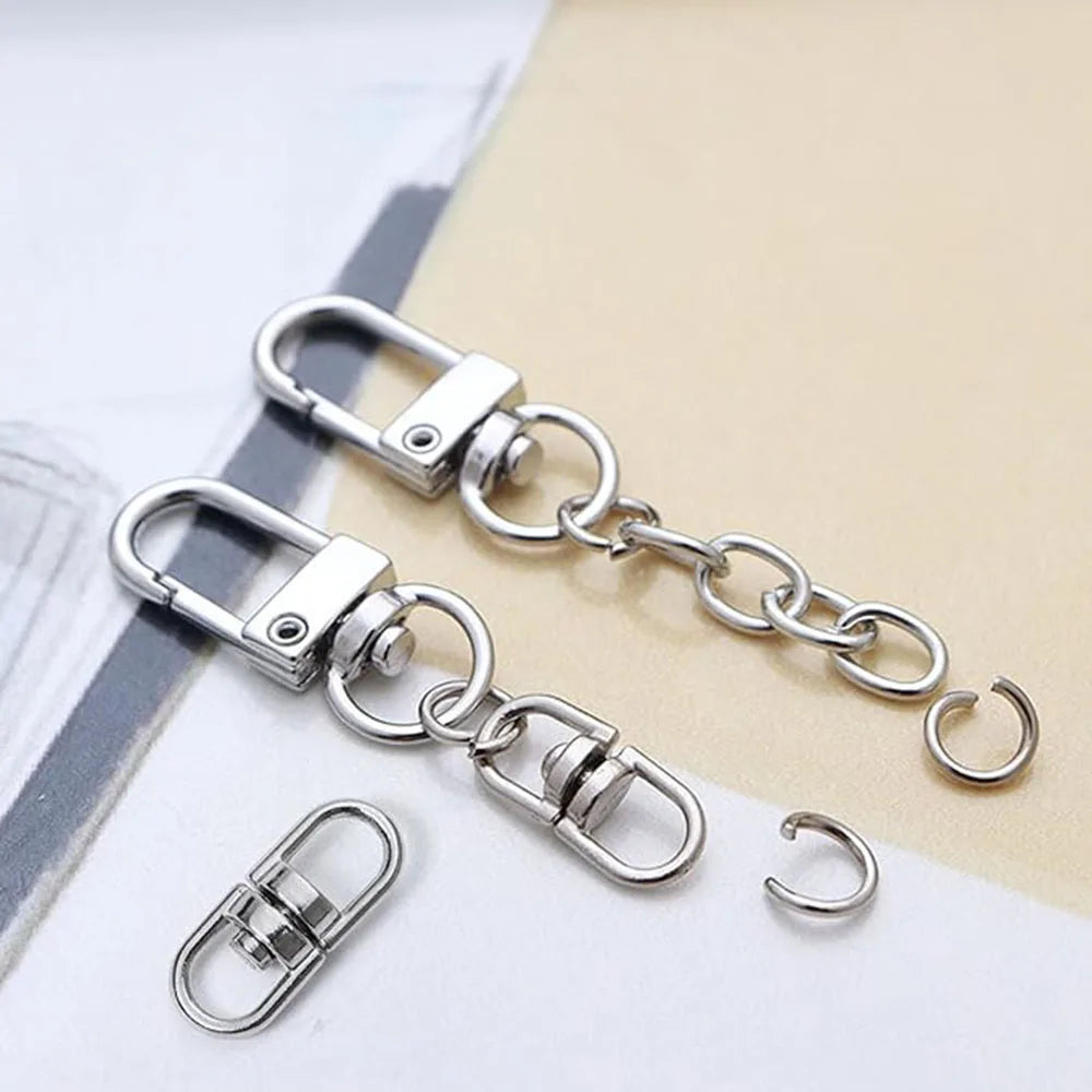 Silver swivel keychain hooks and clasps displayed on a light background.