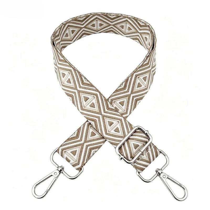 A beige and white patterned nylon shoulder strap for bags and purses.