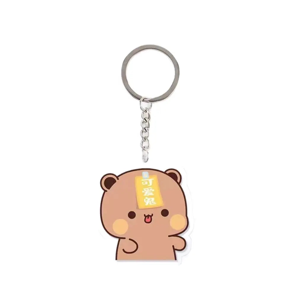 A cute brown cartoon character keychain charm with a silver ring.
