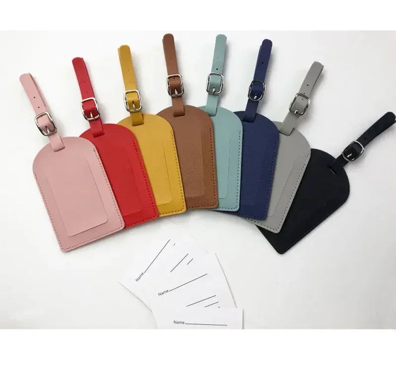 A set of ten PU leather luggage tags in various pastel and earth tones displayed against a white background.