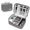 A gray leather cable storage organizer bag with an open lid showing various electronic cables and accessories.