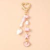 Gold heart-shaped keychain featuring a starfish and pearl accents.