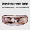 A brown tote bag organizer insert showing a laptop sleeve and various accessories like a watch and pink items.