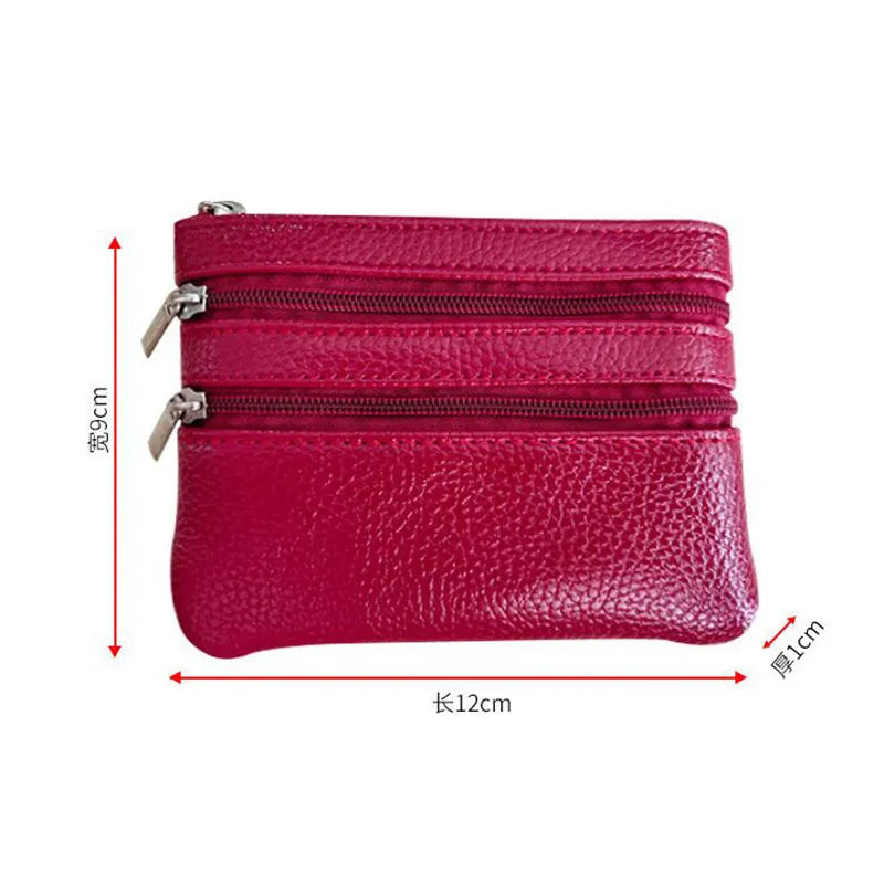 A stack of three magenta PU leather clutch wallets with zippers and stitching.
