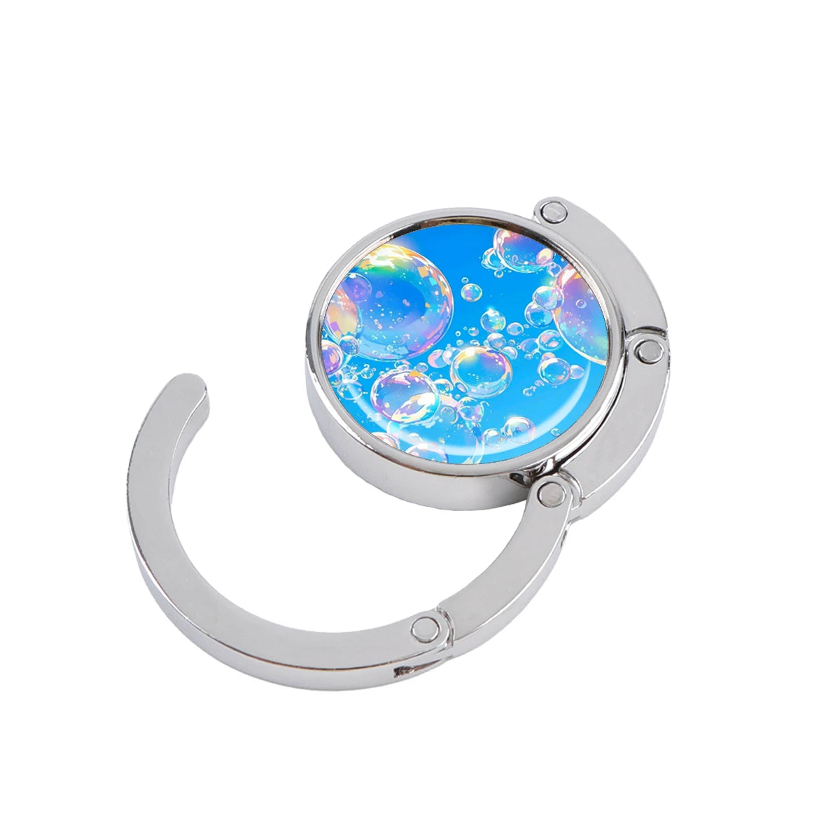 Silver folding table bag hook with a round glass charm showing blue and purple marble starry sky