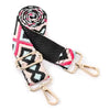A close-up of an adjustable nylon crossbody bag strap featuring a pink and black floral pattern.