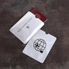 A white RFID passport sleeve is shown next to a maroon card, resting on a dark surface.