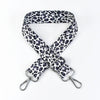 A black and white leopard print adjustable crossbody strap for bags.