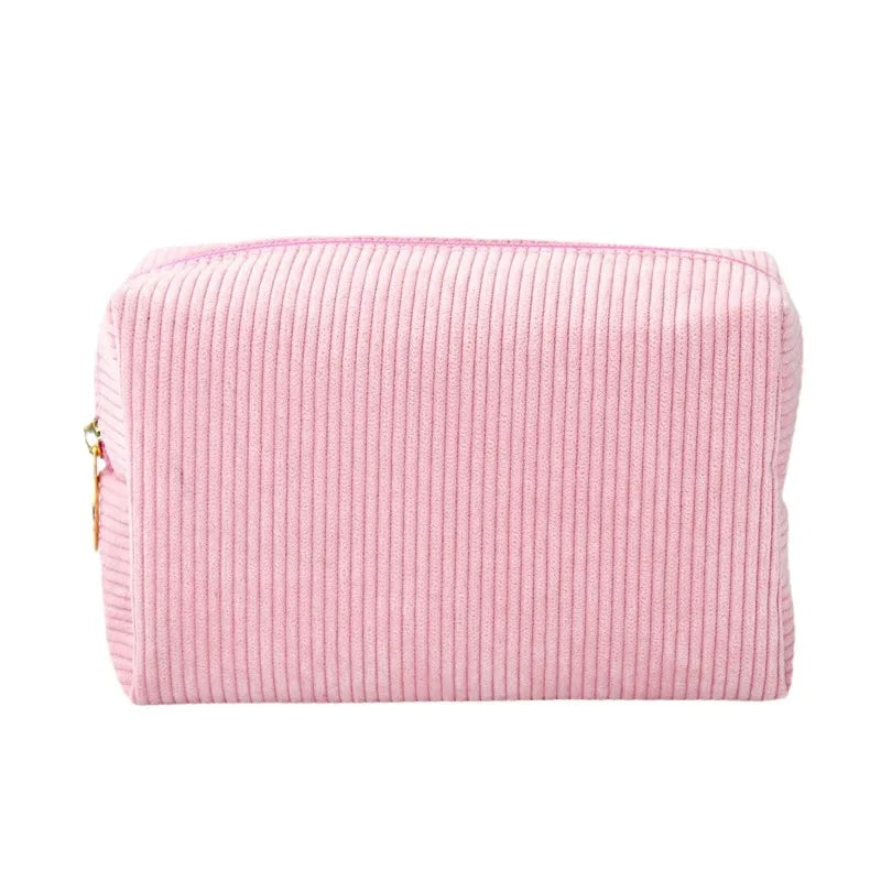 A pink corduroy makeup organizer bag with an octagonal design.