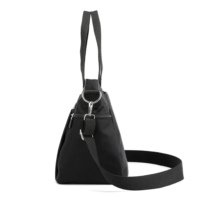 A black durable nylon tote bag with a secure zipper closure and shoulder strap.