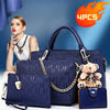A set of four navy blue embossed PU handbags and a wallet displayed against a blue background.