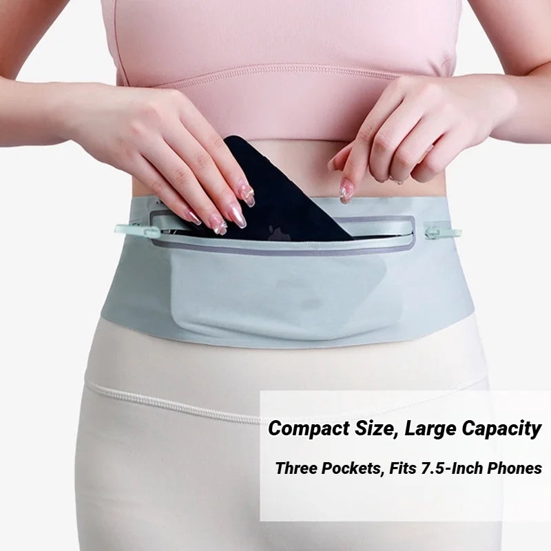 A pink slim waterproof running waist pack is shown being worn around the abdomen of a person.