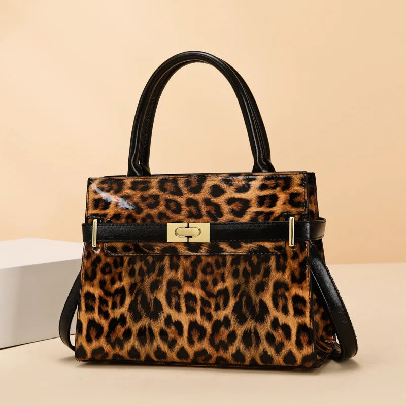 A brown and black leopard print PU leather shoulder handbag with a black leather handle and gold hardware.