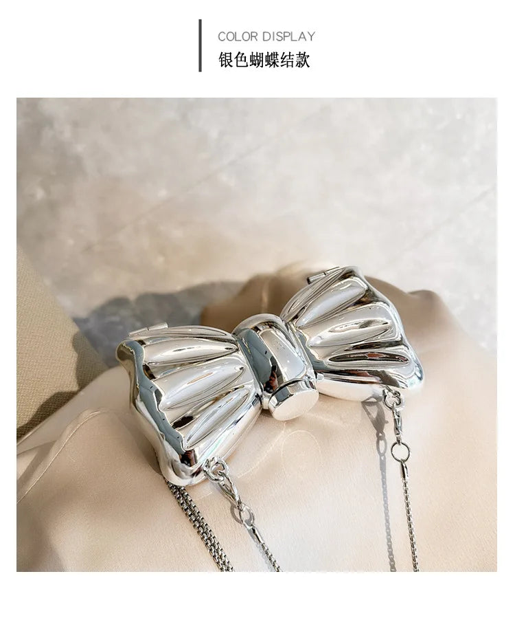 Silver elegant bowknot bag with a metallic finish and detachable chain strap