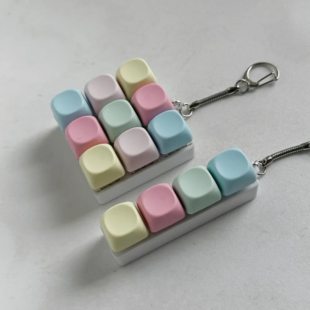 A set of pastel colored tactile stress relief keyboard fidget toys arranged in a triangular shape.